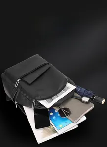 Close-up of black leather business backpack with multi-zipper pockets and lychee texture