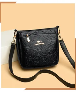 Close-up of black bucket bag featuring 3D rose floral embossing and gold kangaroo logo