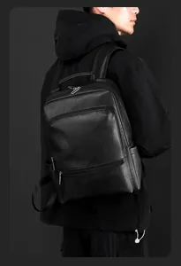 Side view of black lychee leather business backpack showing zippers and side pockets