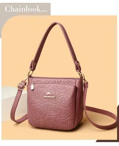 Detailed view of rose flower embossed lychee pattern leather on a pink bucket bag