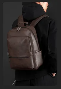 Detail view of vintage dark brown faux leather backpack with rich litchi texture and zippers