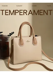 Detailed close-up of beige lychee grain leather tote with golden kangaroo logo and brown handles