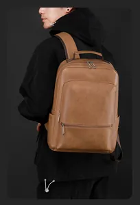 Brown vintage leather business backpack shown on model during commute in studio setting