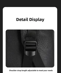 Detail of adjustable nylon shoulder strap and buckle on black lychee leather backpack