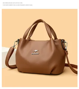 Detailed macro shot of brown pebble grain leather handbag with silver kangaroo logo