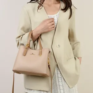 Elegante borsa a mano in pelle beige da donna con logo dorato e finitura testurizzata fine