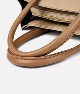 Detail of the high-quality lychee grain leather texture and handle stitching on tote bag