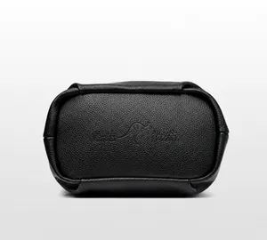 Detail view of the black lychee grain leather handbag bottom featuring embossed kangaroo logo