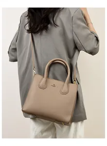 Detailed view of the khaki leather tote bag with elegant texture and gold kangaroo logo