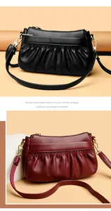 Detail of ruched leather texture and golden hardware on solid color crossbody bags