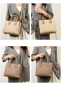 Detail of elegant leather tote bag with metal feet and detachable shoulder strap