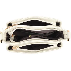 White leather bucket bag with multiple zipper compartments and elegant gold hardware