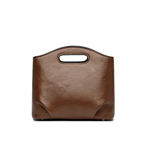 Bolso cubo clásico de cuero marrón oscuro con asa y diseño vintage de textura granulada