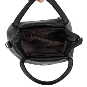 Black lychee leather handbag showing spacious interior compartments and brown lining