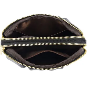 Minimalist black leather envelope handbag with double zippers and interior storage detail