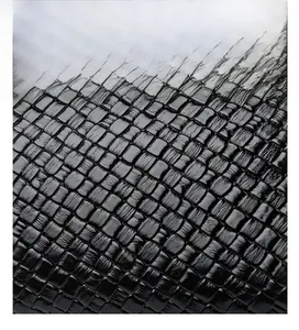 Macro detail of high-quality black woven leather texture on a stylish small square handbag