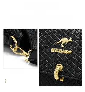 Detail of golden hardware buckle and logo on black woven leather crossbody bag