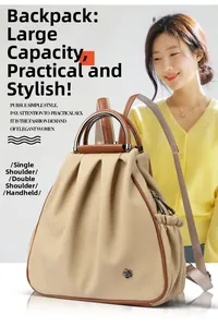 Detail of beige woven backpack with metal handle, pleated texture and black floral logo