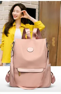 Detail of pink waterproof backpack with leather accents and convertible straps