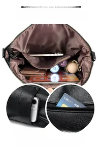 Detail of black pebbled leather bucket bag showing large capacity interior and side pockets