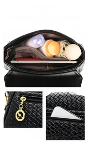 Detailed view of the black woven leather handbag interior with multi-compartment storage