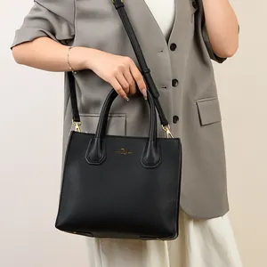 Elegant black lychee grain leather tote bag with gold hardware for professional women
