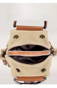 Detail view of beige woven bag interior showing spacious compartments and magnetic snaps