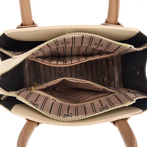 Internal view of leather tote bag with striped lining and multi-compartment storage