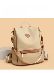 Detail of British style canvas backpack with leather trim and kangaroo logo on front
