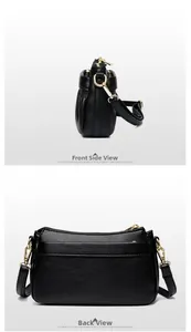 Detail of black pebbled leather crossbody bag with pleated sides and gold zipper hardware