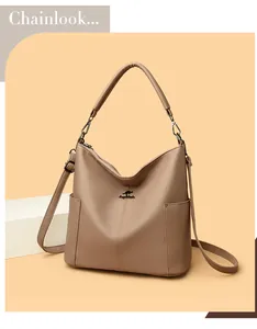 Detail of brown litchi pattern leather bucket bag showing kangaroo logo and side pockets