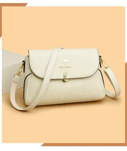 Detail of woven square texture on ivory leather bag with golden metal logo and buckle