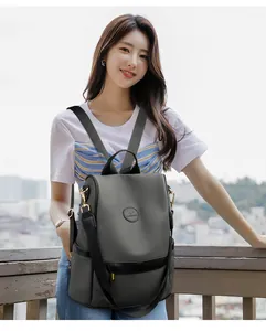 Detail view of water-resistant dark grey nylon backpack with anti-theft back zipper