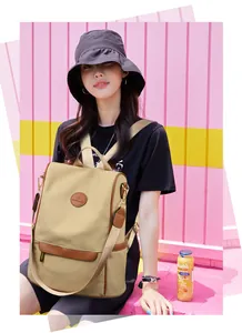 Detail of khaki water-resistant backpack with leather trim and convertible straps