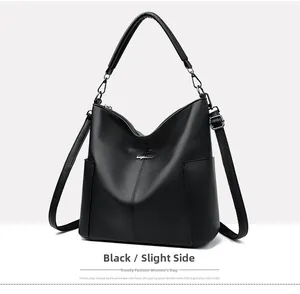 Detail of black pebbled leather bucket bag with silver logo and side pockets
