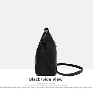 Side view of black lychee leather bucket bag with silver metal buckles and shoulder strap