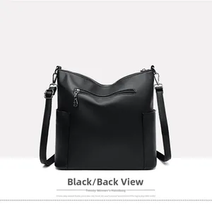 Detail view of the black pebble leather bucket bag showing back zip pocket and side slots