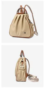 Detail view of khaki canvas backpack with brown leather trim and metal flower hardware