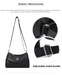 Detail of hardware with multi-layer plating and adjustable strap on black woven bag
