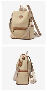 Detail view of water-resistant canvas backpack with leather trim and side pocket