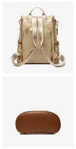 Detail view of the khaki fabric and brown leather base of the vintage backpack