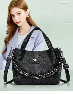 Detail of black snakeskin pattern leather bag with silver kangaroo logo and thick chain