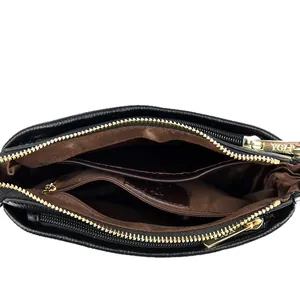 Solid black leather crossbody bag with three interior compartments and gold hardware