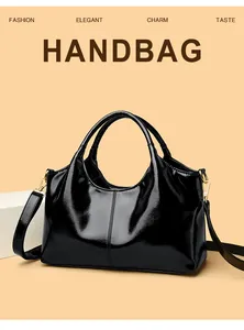 Glänzende schwarze Lackleder-Handtasche mit goldenen Beschlägen und eleganter Trapezform