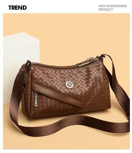 Detailed view of dark brown woven leather crossbody bag with kangaroo logo and strap