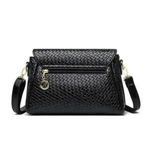 Woven leather crossbody bag for women with gold kangaroo charm and chain strap