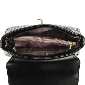 Interior view of black woven leather handbag with multi-layer compartments and gold hardware