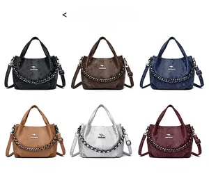 Detail view of snakeskin textured leather bags with metal chains in six elegant colors