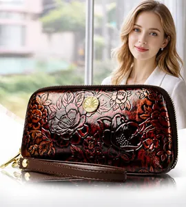 Detail of red embossed leather clutch with 3D peony flower and golden metal logo