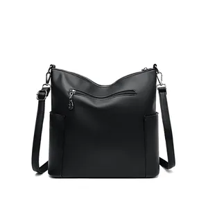 Black pebbled leather bucket bag with top handle and multiple zipper pockets